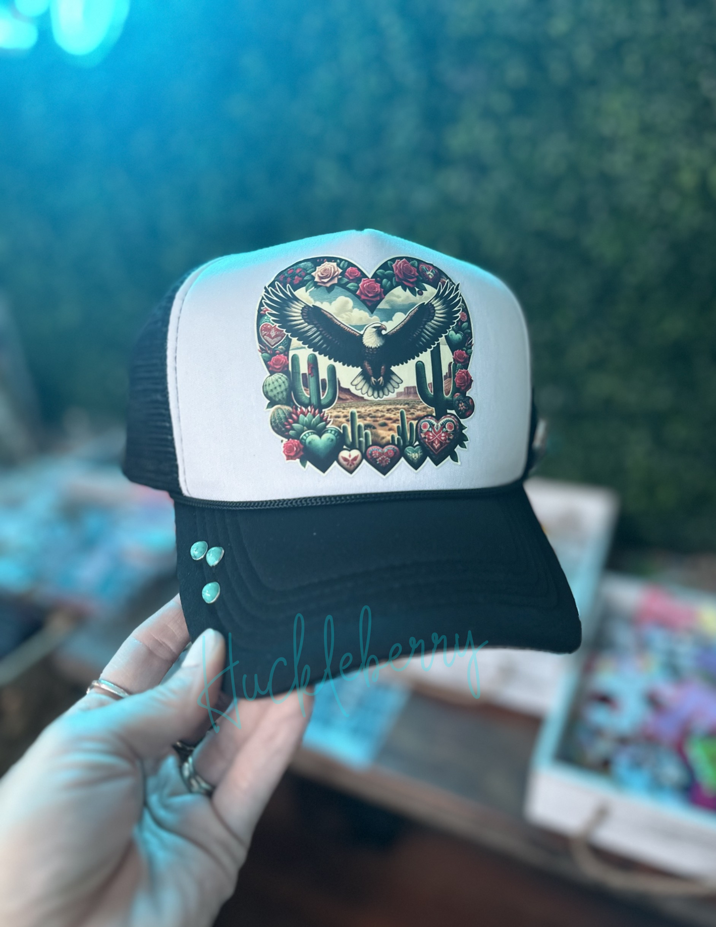 Trucker with Eagle soaring in a western scene. Accented with 3 turquoise rivets and 1 concho